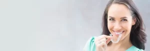 woman holding suresmile aligners